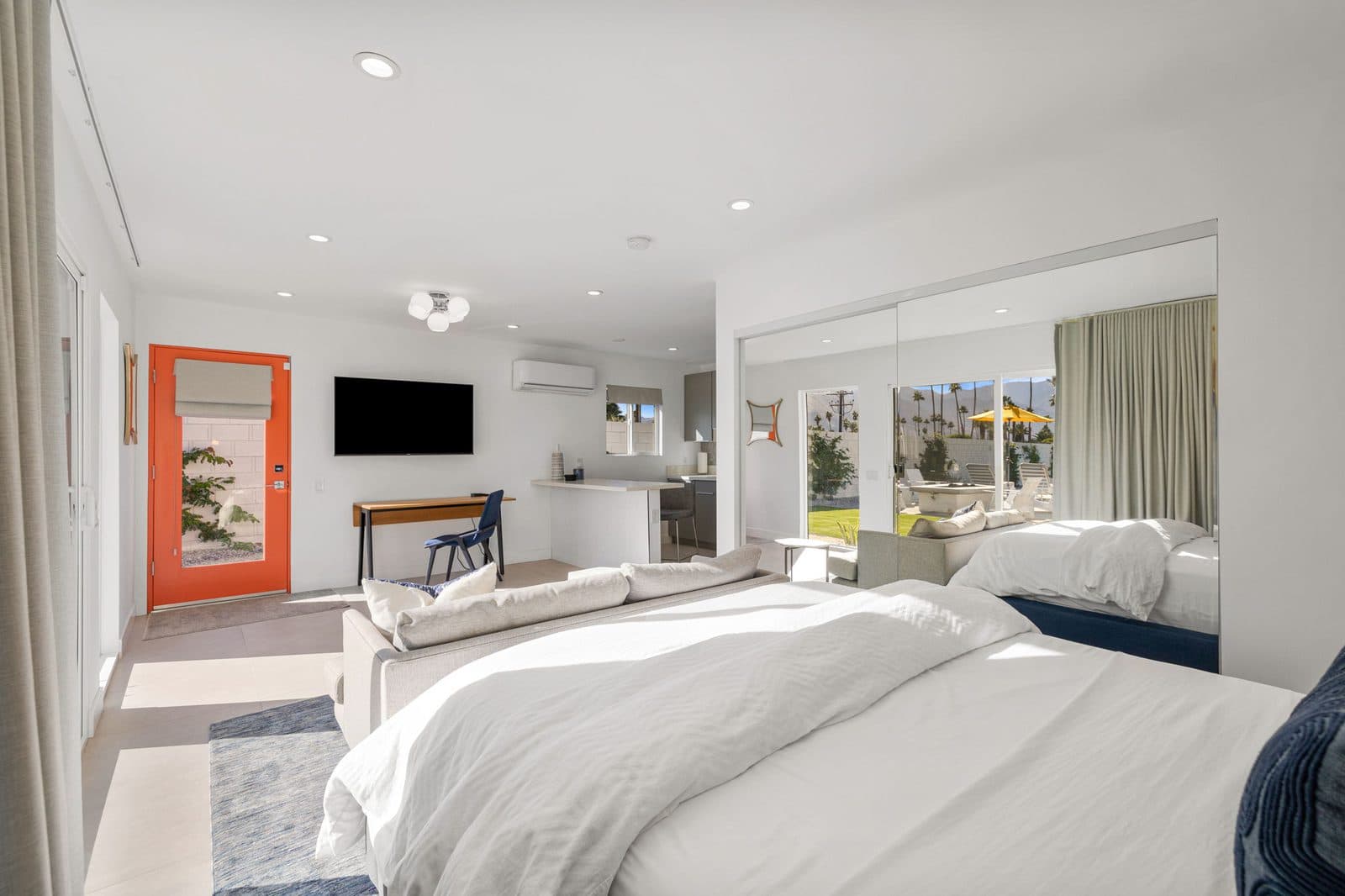 Casita suite with a queen bed, sofa, and TV