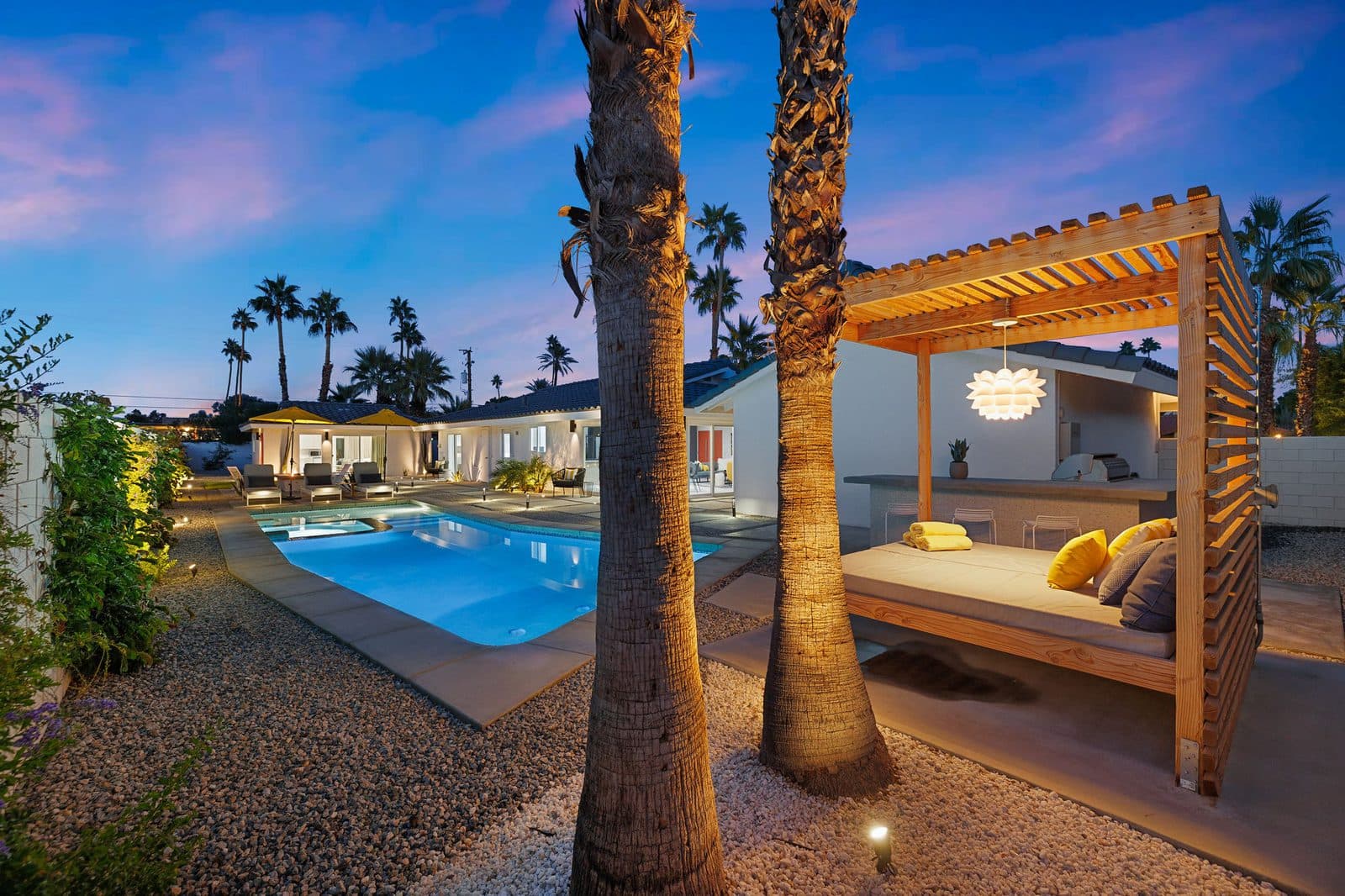 Pool and hot tub at twilight with the cabana daybed