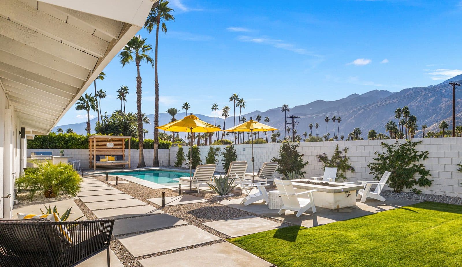 Full backyard with pool, lawn, and mountains